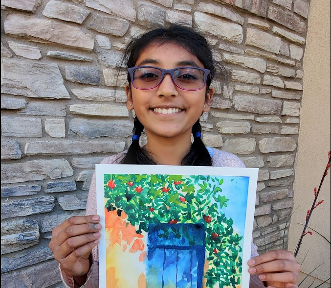 Female student holding her art work